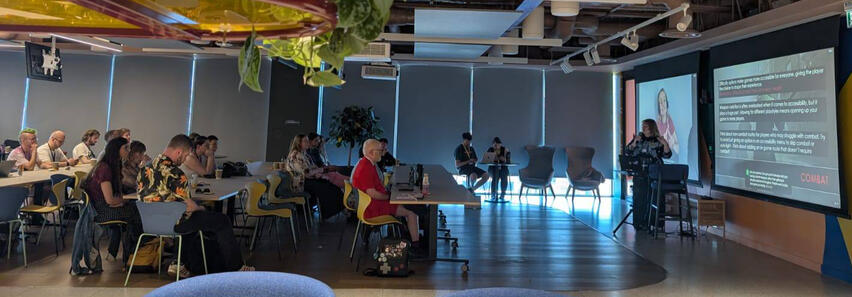 a photo of Spoonie irl doing a talk on accessibility in horror at game a11y gathering 2025